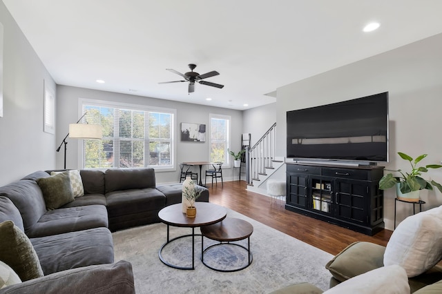 living room with dark wood-type flooring and ceiling fan