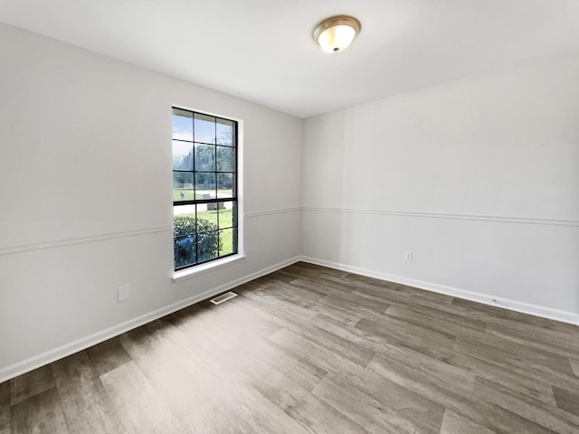 spare room with hardwood / wood-style flooring