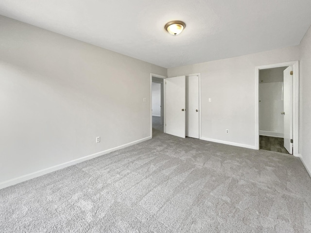 unfurnished bedroom with carpet flooring and a closet