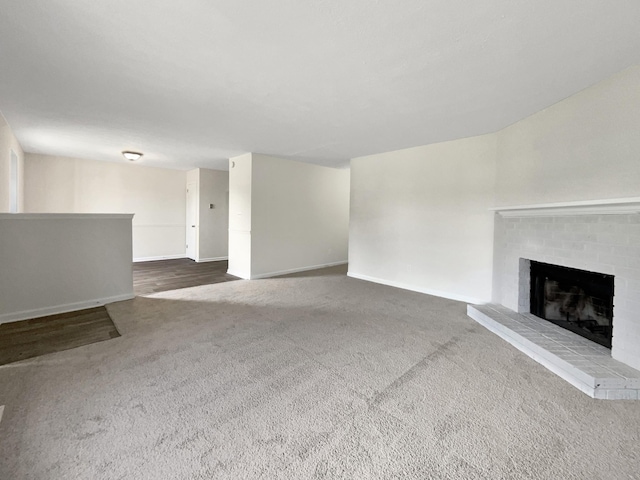 unfurnished living room featuring carpet floors and a fireplace