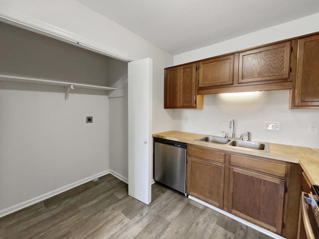 kitchen with butcher block countertops, dishwasher, light wood-type flooring, and sink