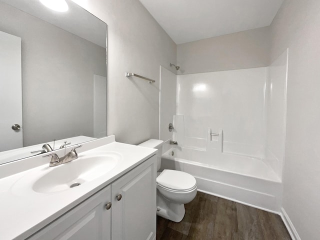 full bathroom featuring vanity, wood-type flooring,  shower combination, and toilet