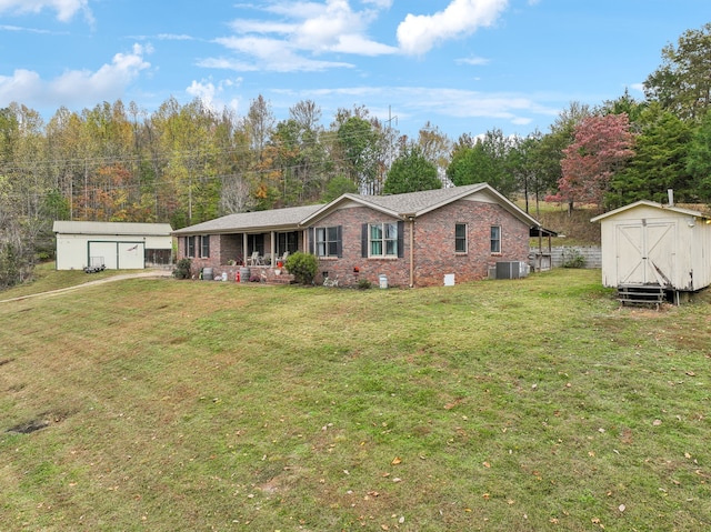 view of front of home featuring a front yard, a shed, and cooling unit