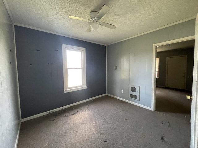 unfurnished room featuring ceiling fan, crown molding, a textured ceiling, and heating unit