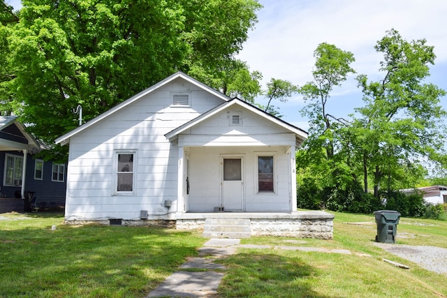 bungalow-style home featuring a front lawn