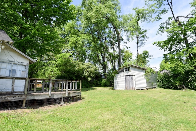 view of yard with a deck and a shed