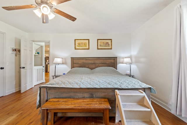 bedroom with light hardwood / wood-style floors and ceiling fan