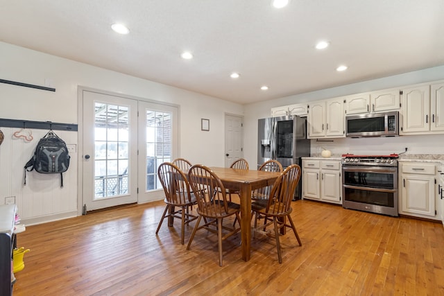 dining space with light hardwood / wood-style flooring