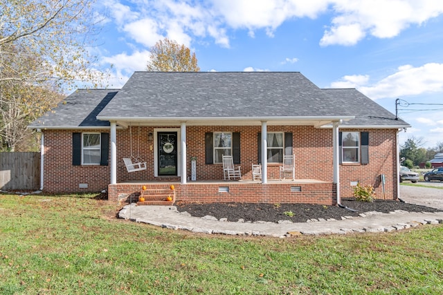 bungalow-style home featuring covered porch and a front yard