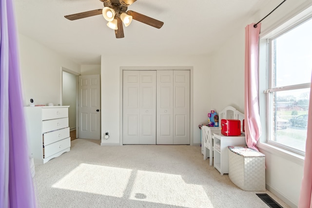 bedroom featuring ceiling fan and light colored carpet