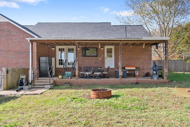 rear view of property with a yard and a patio