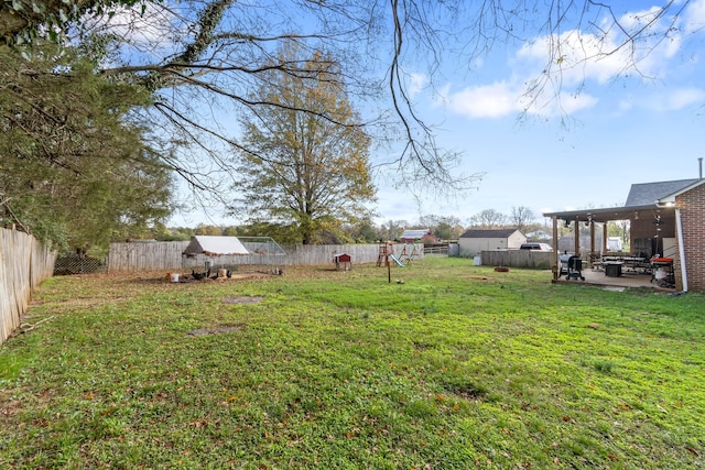 view of yard with a playground and a patio