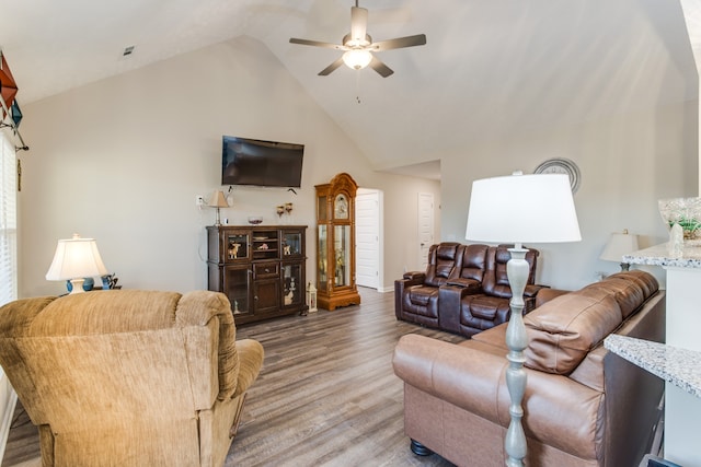 living room featuring hardwood / wood-style floors, high vaulted ceiling, and ceiling fan