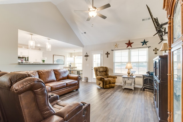 living room featuring hardwood / wood-style floors, high vaulted ceiling, and ceiling fan