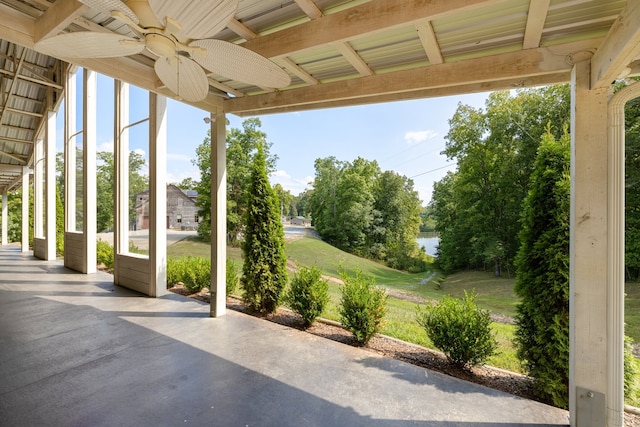 view of patio featuring ceiling fan and a water view