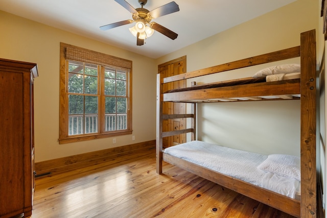 bedroom with light hardwood / wood-style flooring and ceiling fan