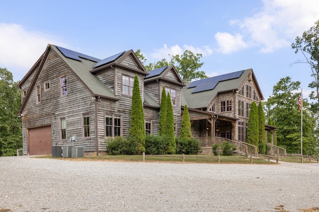 view of front of home with solar panels and a garage