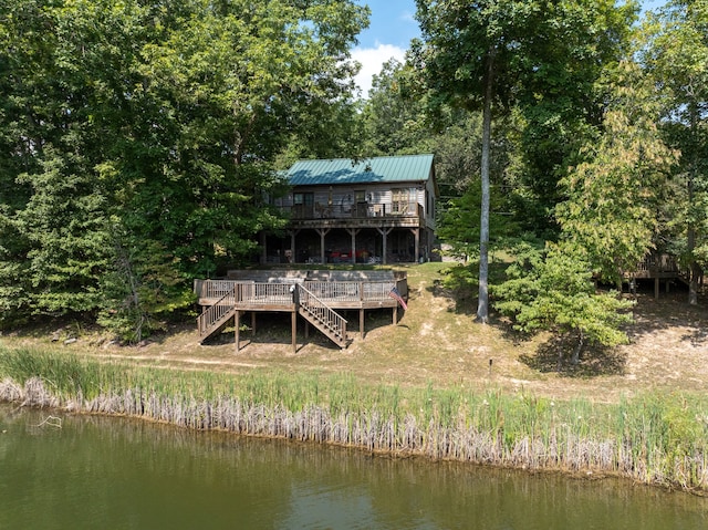 rear view of property with a deck with water view