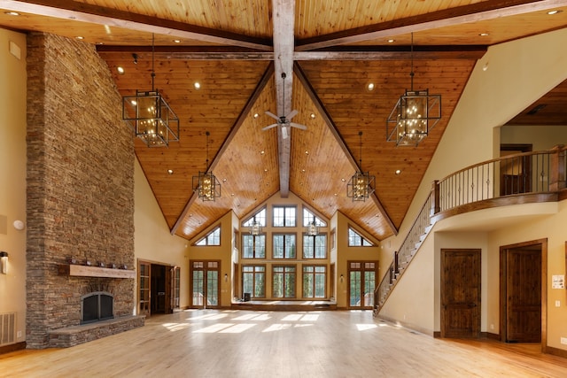 unfurnished living room with light hardwood / wood-style floors, wooden ceiling, and high vaulted ceiling