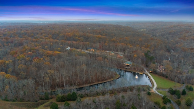 aerial view at dusk featuring a water view