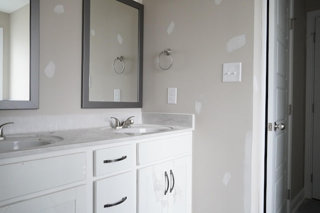 full bath featuring a sink and double vanity