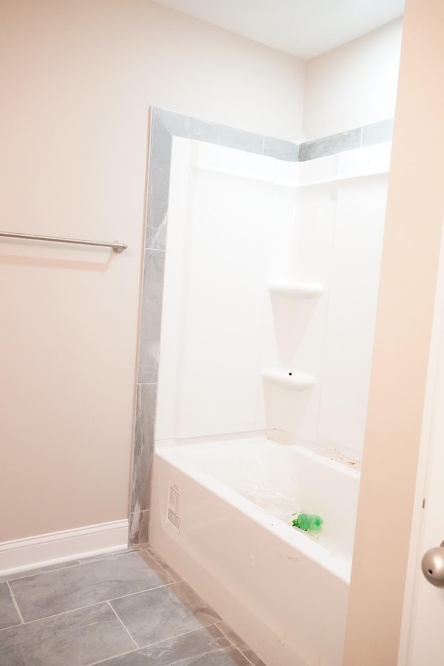 full bath with washtub / shower combination and baseboards