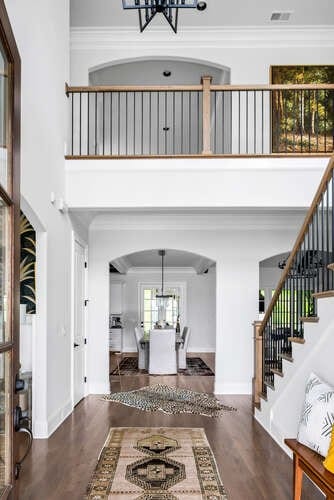 entrance foyer with crown molding, a chandelier, and dark hardwood / wood-style flooring