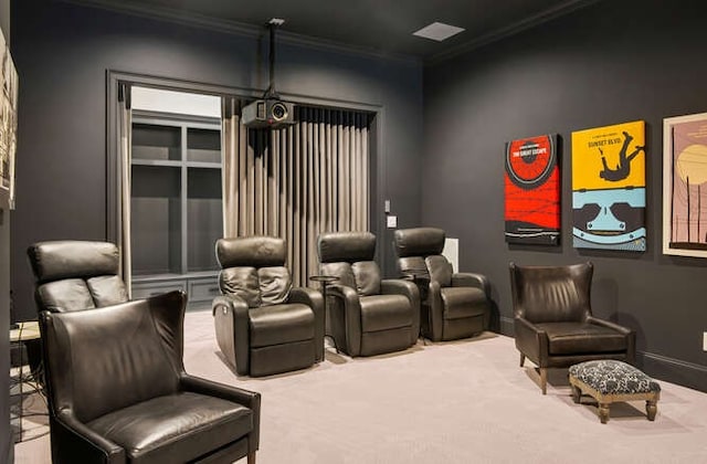 carpeted home theater room featuring crown molding