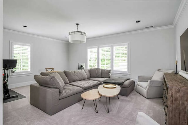 carpeted living room with ornamental molding and plenty of natural light