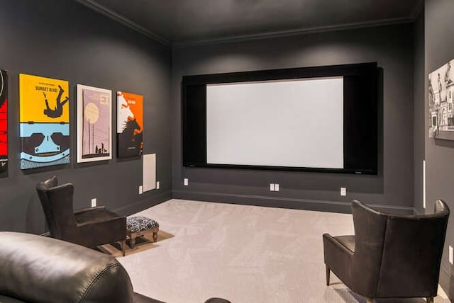 home theater room featuring light carpet and ornamental molding