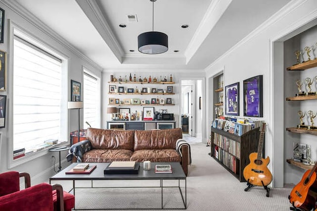 living room featuring ornamental molding, light carpet, a tray ceiling, and plenty of natural light