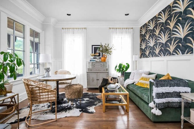 living area with crown molding, wood-type flooring, and plenty of natural light