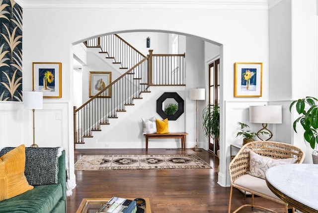 entryway featuring crown molding and dark hardwood / wood-style flooring