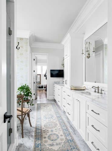 bathroom featuring vanity, ornamental molding, and walk in shower