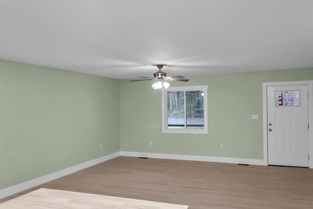 empty room featuring ceiling fan and light hardwood / wood-style floors