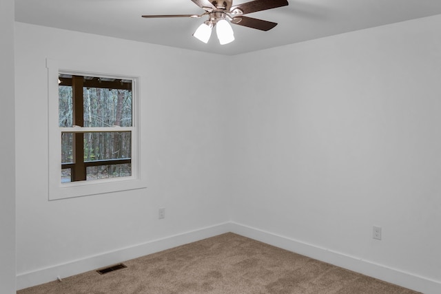 carpeted spare room with ceiling fan