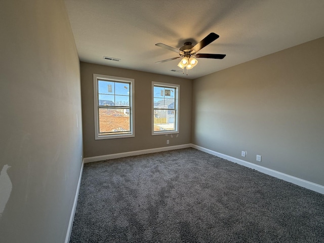 unfurnished room featuring dark carpet and ceiling fan