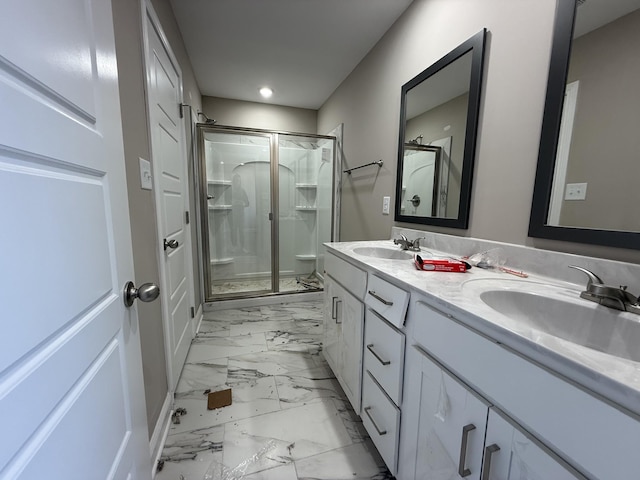 bathroom with vanity and a shower with shower door