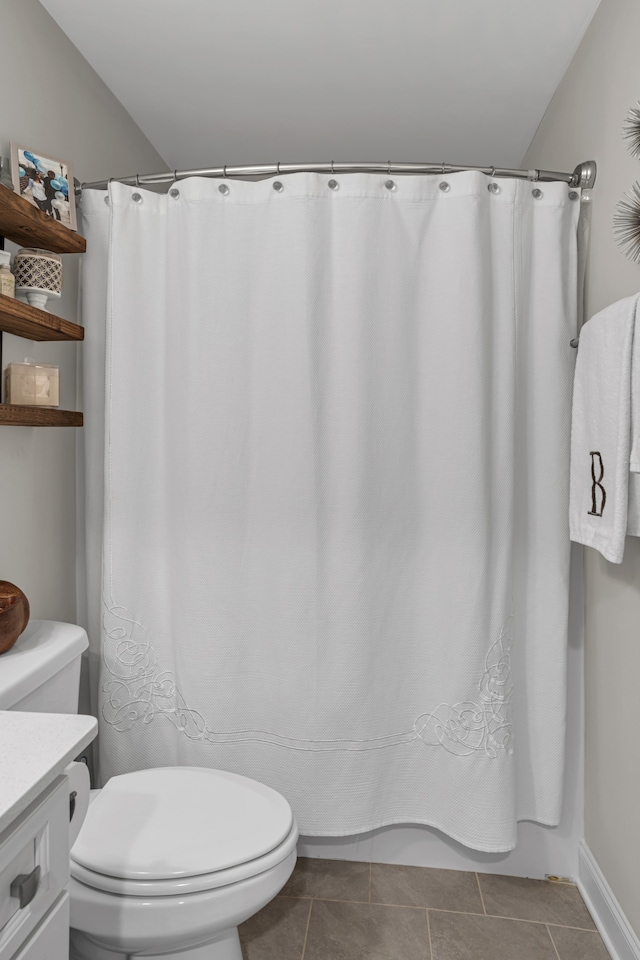 bathroom featuring a shower with curtain, vanity, tile patterned floors, and toilet