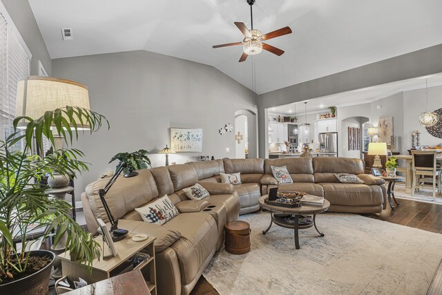 living room featuring ceiling fan, vaulted ceiling, and hardwood / wood-style floors