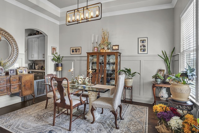 dining room with a notable chandelier, dark wood-type flooring, and plenty of natural light