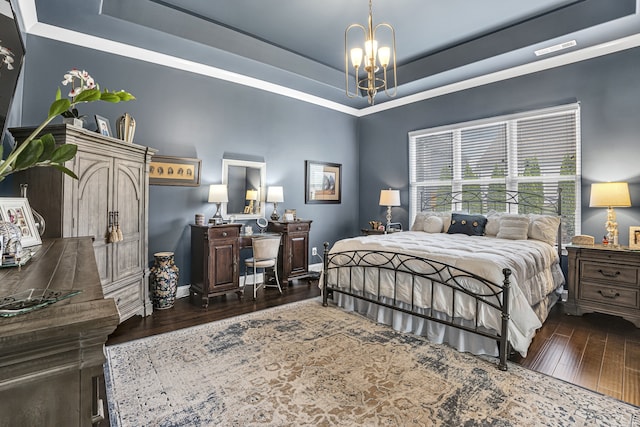 bedroom with dark hardwood / wood-style flooring, a raised ceiling, and a notable chandelier