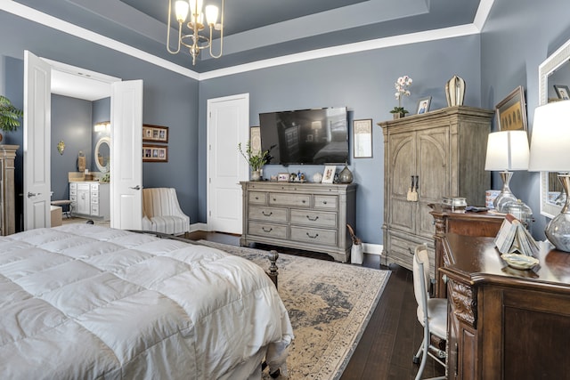 bedroom featuring dark hardwood / wood-style floors, a tray ceiling, and a notable chandelier