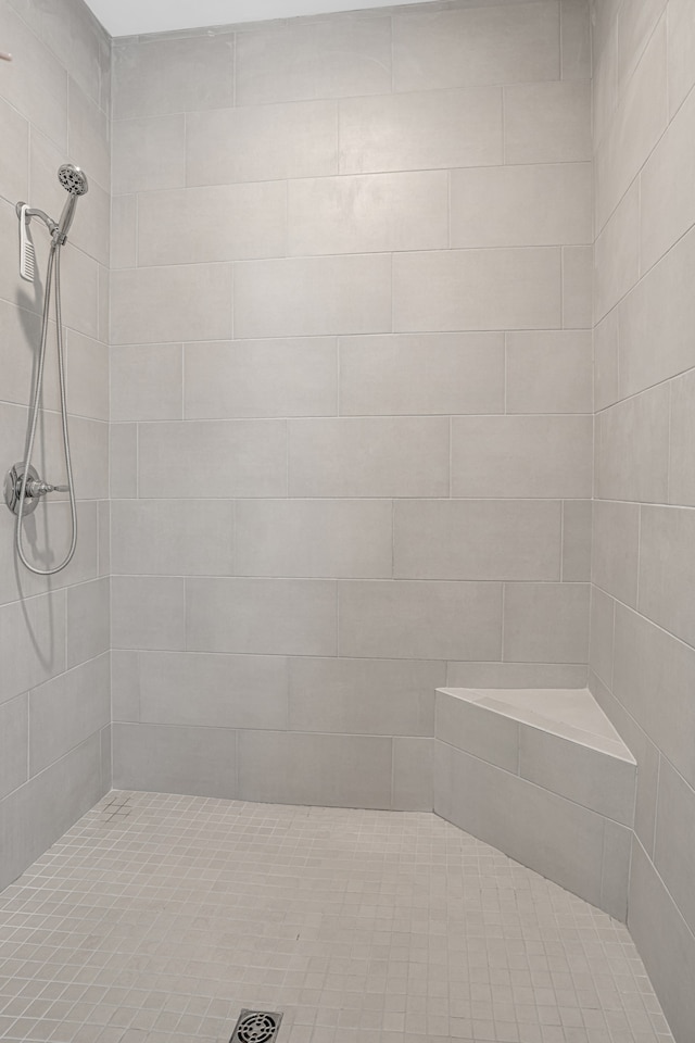 bathroom with a tile shower