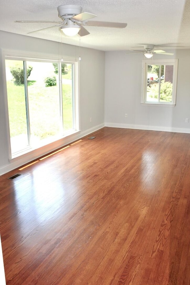 spare room with hardwood / wood-style floors and a textured ceiling