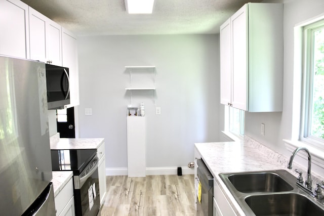 kitchen featuring white cabinets, a wealth of natural light, and appliances with stainless steel finishes