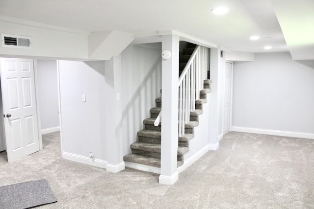 basement featuring light carpet