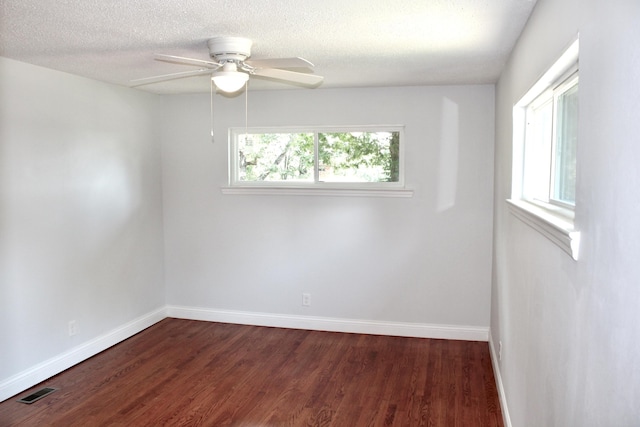 unfurnished room featuring ceiling fan, a textured ceiling, and dark hardwood / wood-style flooring