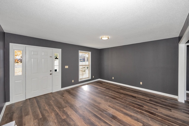 entrance foyer featuring a textured ceiling and dark hardwood / wood-style floors