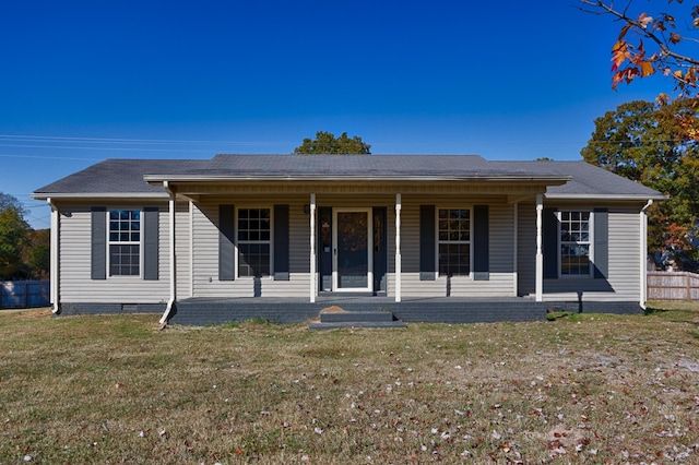 ranch-style home featuring a front lawn and covered porch